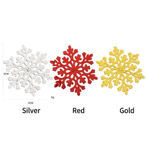 Three 9cm decorative Christmas snowflakes in silver, red, and gold glitter finishes