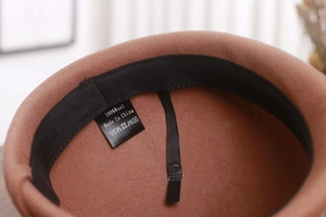 Detail of wool cap interior showing the 100% pure wool label and high quality stitching