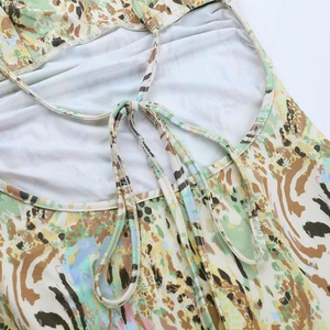 Detail of the lace-up back design and colorful abstract print on a summer beach dress