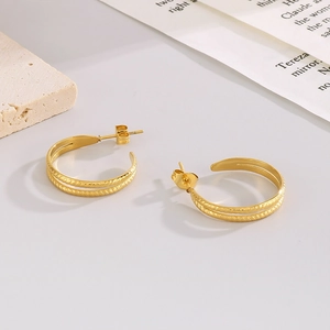 Golden C-shaped stainless steel earrings with textured and smooth double-layer design