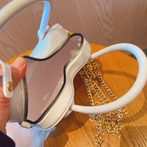 Detailed internal view of the white heart-shaped PVC jelly bag with gold chain strap