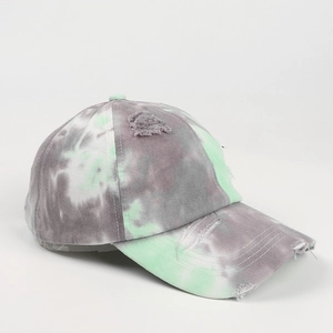 Detail of distressed tie-dye baseball cap featuring vintage frayed edges and stitching