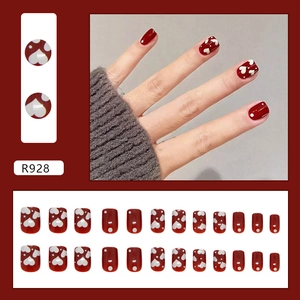 Deep red press-on nails set with white heart and dot patterns in short square shape
