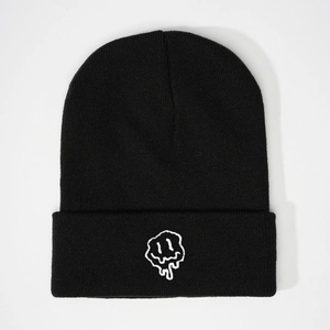 Classic black knitted beanie featuring a white embroidered melting smiley face on cuff