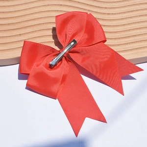 Detailed view of a 6-inch red grosgrain ribbon bow with a silver alligator hair clip
