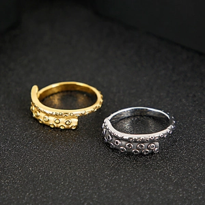 Detailed close-up of vintage octopus tentacle rings in gold and silver finishes