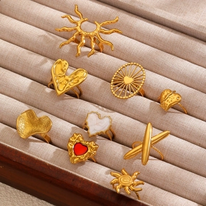 Golden stainless steel rings with enamel heart and sun designs in vintage textured style