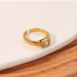 Macro shot of 18k gold plated ring featuring a rectangular zircon and textured band