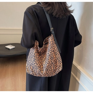 Retro leopard print canvas crossbody bag with adjustable black leather shoulder strap