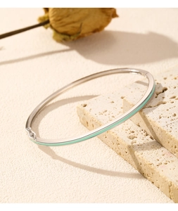 Close-up of s925 silver bracelet with mint green enamel inlay and side clasp buckle