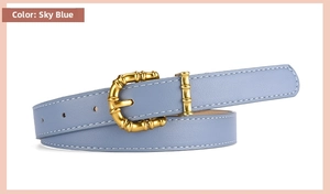 Close-up of sky blue PU leather belt with unique gold bamboo buckle and fine stitching