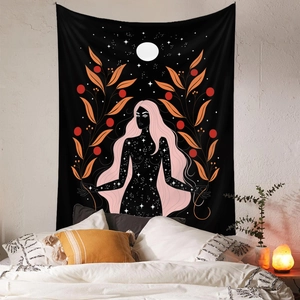 Detail of bohemian black wall tapestry with starry girl illustration in cozy bedroom decor