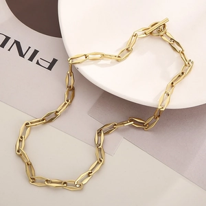 Detail of gold-plated OT toggle clasp and geometric chain links on fashion necklace