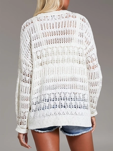 Back view of a white hollow knit long-sleeve beach coverup with crochet texture