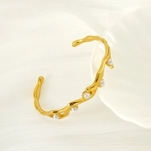 Elegant gold titanium open bangle featuring irregular wave design and pearl accents