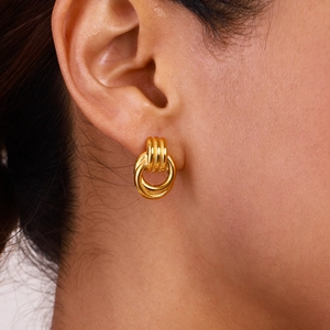 Golden triple knot stainless steel earrings shown on a model for a stylish look