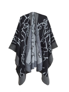 Detailed texture of black and grey jacquard knit shawl with abstract ink floral motifs