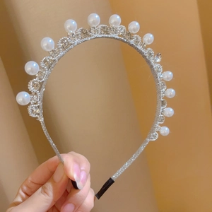 Close-up of vintage flower pearl headband with rhinestones and black comfort tips