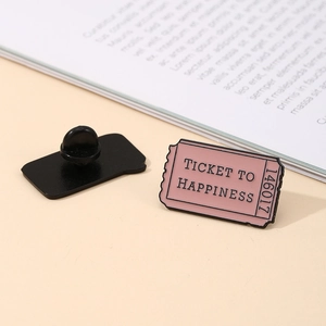 Pink enamel ticket brooch with Ticket to Happiness print and black butterfly clasp