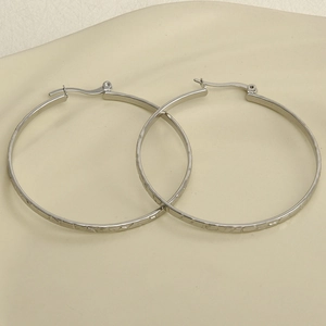 Detailed view of silver 304 stainless steel U-shaped earrings with hammered metal texture