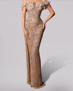 Detail of champagne gold evening dress featuring 3D leaf embroidery and sequins