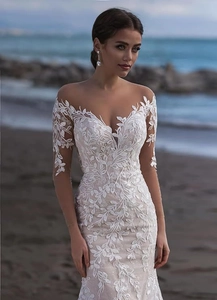 Exquisite mermaid lace wedding dress with off-the-shoulder deep V-neck and long sheer sleeves