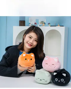 Close-up of cute plush cat keychains in four colors with soft fabric texture