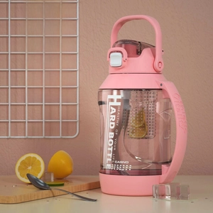 Detail view of 1900ML pink sports bottle with removable filter and sturdy handle