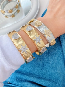 Detailed view of adjustable gold and silver heart star bangles with micro-pave zircons