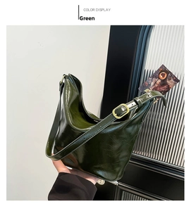 Detail of green patent leather hobo bag with vintage gold buckle and glossy texture