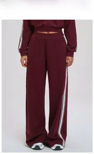 Detail of retro red tracksuit showing side white stripes on pants and cropped hoodie