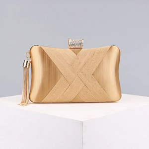 Detailed view of luxury gold evening clutch with pleated satin and crystal clasp