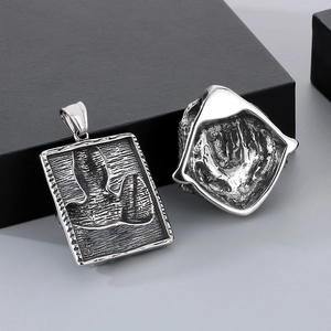 Vintage silver punk plague doctor and wolf head pendants on gray background