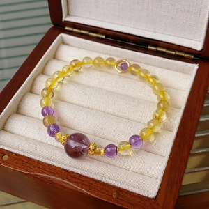 Detail of amethyst and citrine beaded bracelet displayed in a premium jewelry gift box