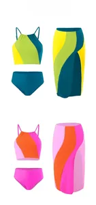 Detailed flat lay of three-piece swimsuit sets with color-block tops and matching skirts