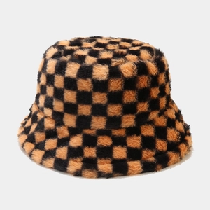 Detailed macro view of the soft black and orange checkered plush faux fur bucket hat fabric