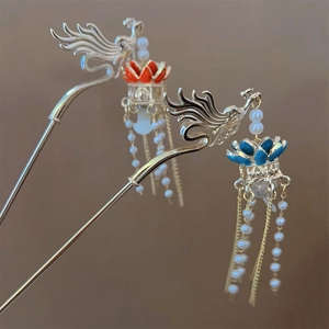 Close-up of golden phoenix hairpins with lotus design, pearls and flowing tassels