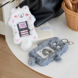 Detail of plush cat photocard holders in white and grey with metal keychains and windows