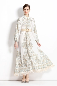 Détail d'une robe à imprimé paisley avec ceinture tressée et ourlet à pompons blancs
