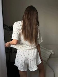 Rear view of floral loungewear set with ruffle hem shorts and ribbed cherry print fabric
