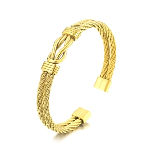 Polished gold cable twisted wire cuff bracelet with a double loop knot design