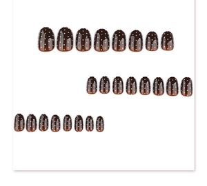 Macro shot of 24pcs brown press-on nails with white polka dots in oval shape