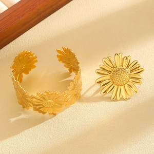 Detail of golden sunflower bracelet and ring set with intricate petal textures