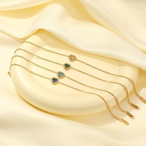 Elegant gold plated heart bracelets set with colorful zircon stones in a luxury dish