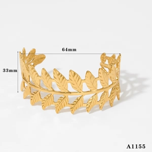 Detail view of 18K gold plated wide cuff bracelet with Greek leaf cutout pattern