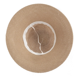 Detail of wide brim straw hat interior showing the sweatband and adjustable drawstring