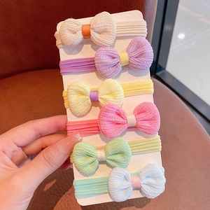 Set of six pastel bow hair ties for girls in soft macaron colors on card holder