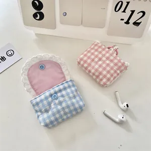 Detailed view of quilted checkered lace protective sleeves for wireless earbuds in pink and blue