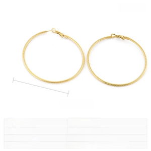 Detail view of large golden twisted hoop earrings measuring fifty millimeters in diameter