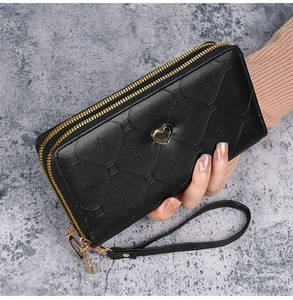 Detail of black long leather wallet with heart metal buckle and double zipper closure